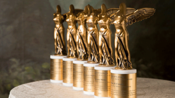 A row of Lasker Award statues, each a gold headless angel statue on a base